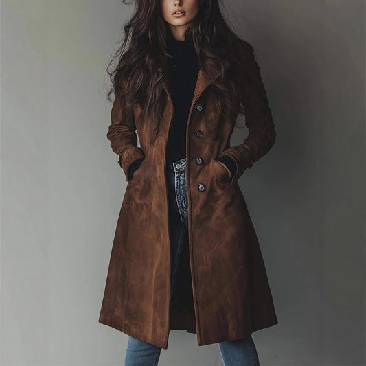 Woman wearing a brown leather coat against a plain background