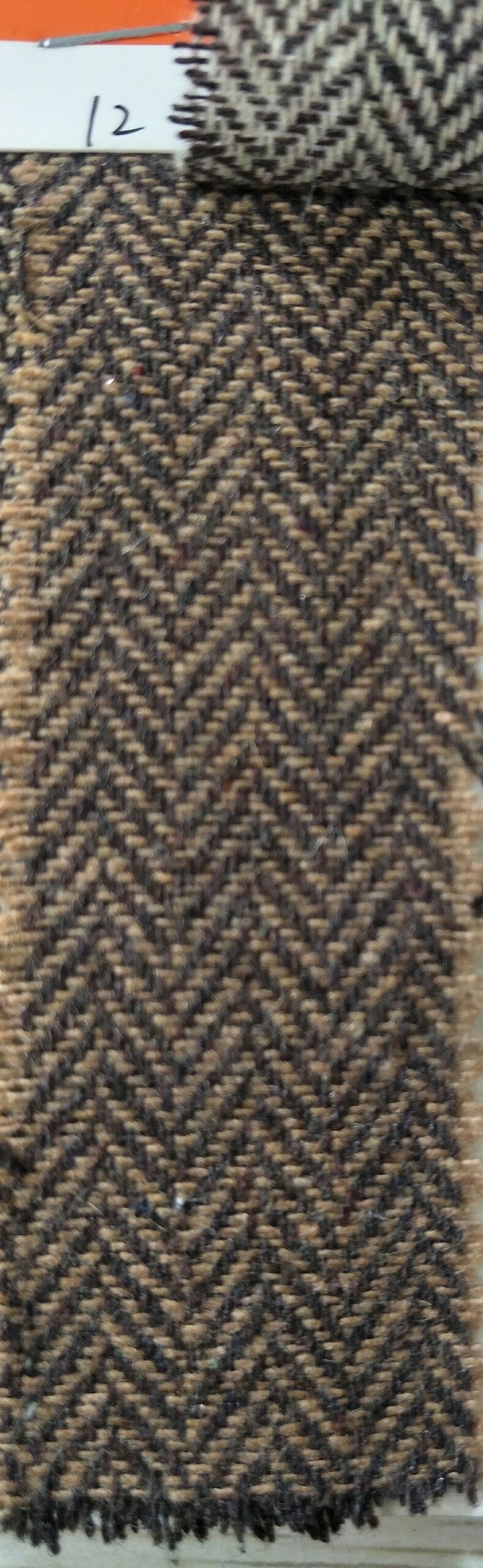 Herringbone pattern fabric swatch in brown and black